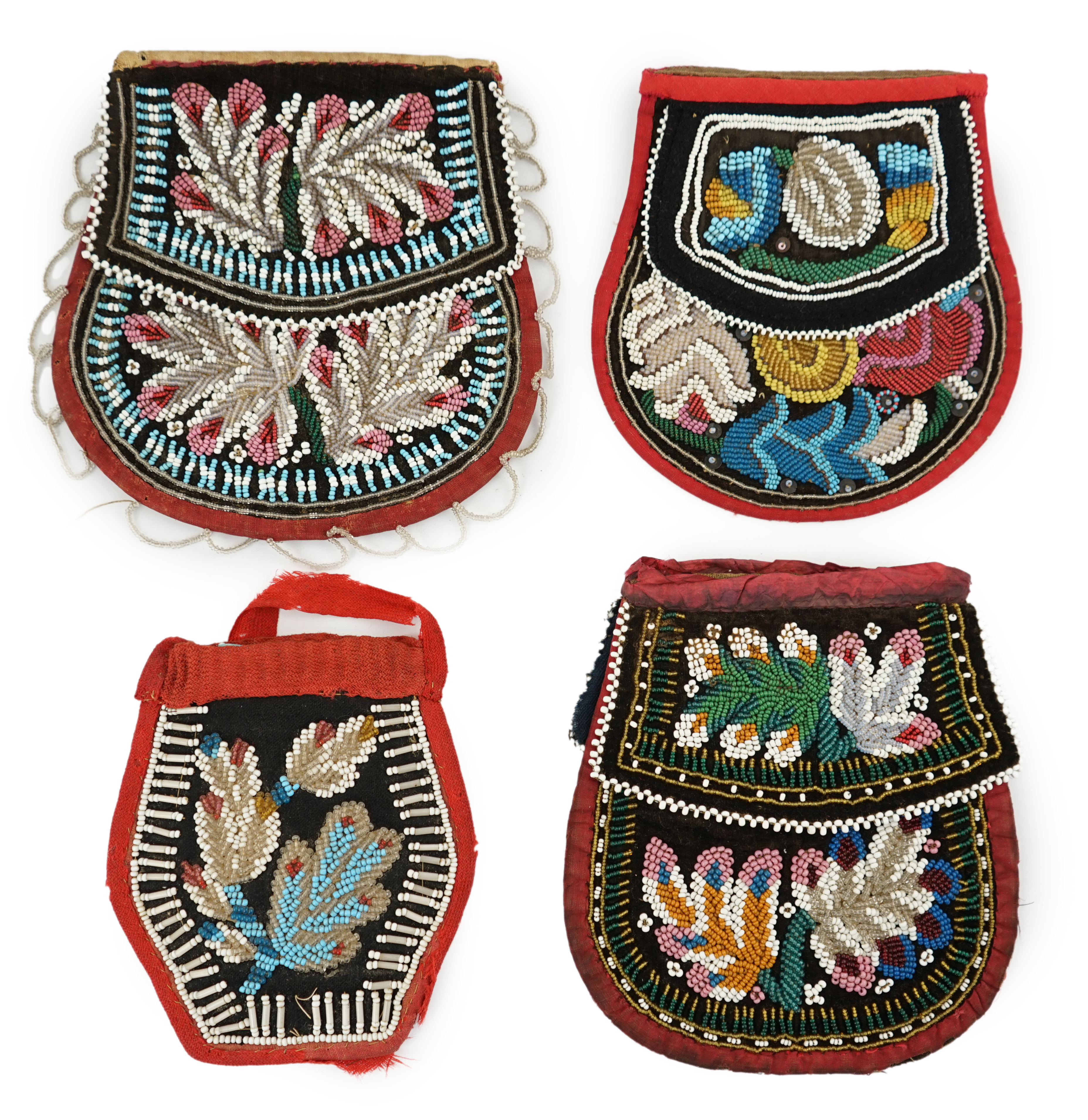 Three 19th century Iroquois Native American beaded bags and a smaller pouch, the bags have beaded flaps, the pouch is shaped with mostly white and turquoise beading having a red fabric edging, all four have very differen